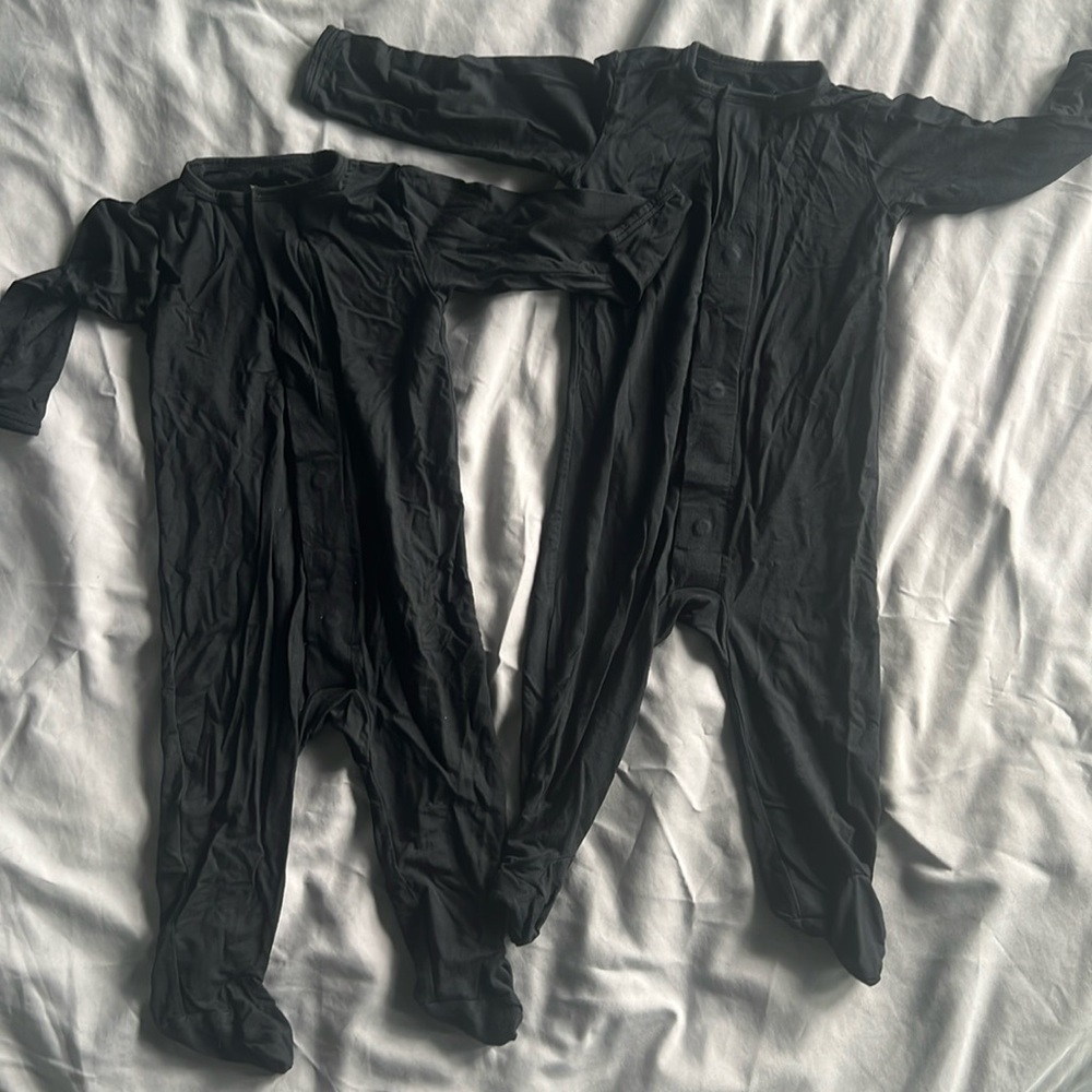 Two black magnetic me footsie onesies